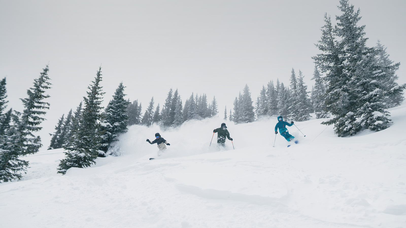 three friends skiing powder