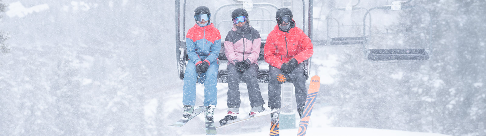 skiers on lift in snow